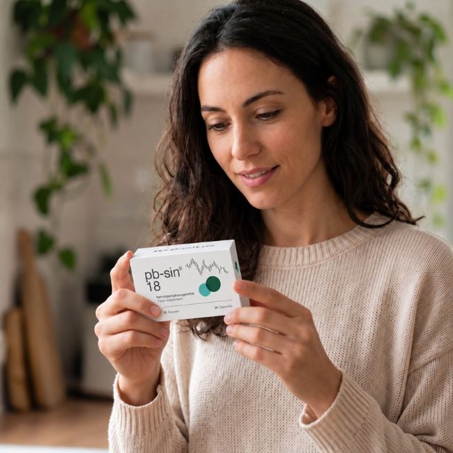 Woman looking at a pb-sin 18 package